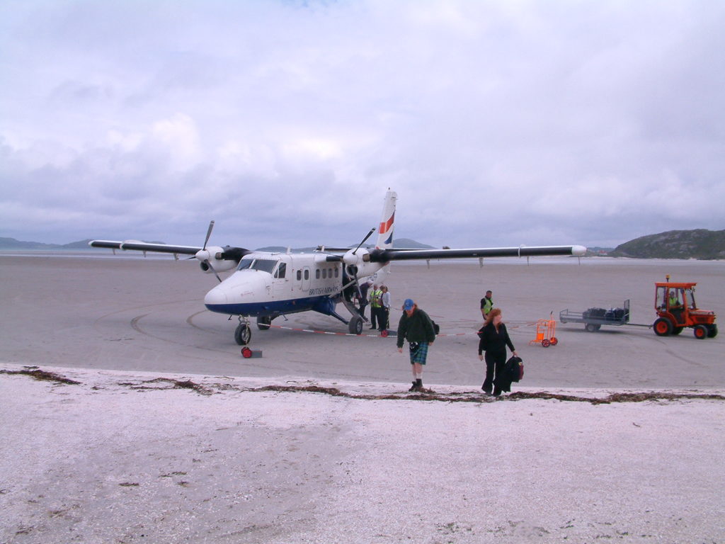 Walking across the sand of Barra beach to reclaim our baggage