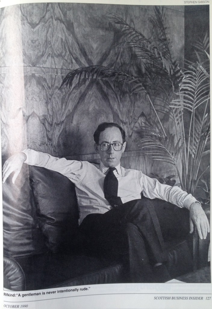 Malcolm Rifkind in shirt sleeves on leather sofa