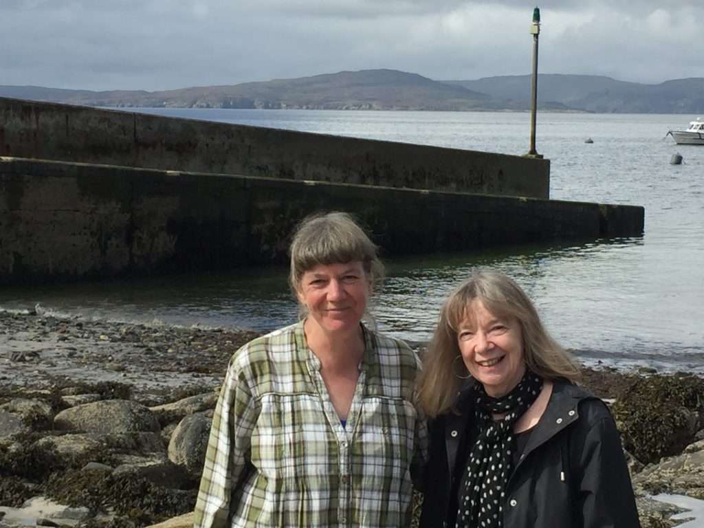 Anne Cholawo and Fay Young by Elgol jetty with Soay on the horizon